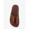 Low leather sandals with metal studs on the sides