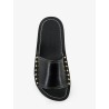 Low leather sandals with metal studs on the sides